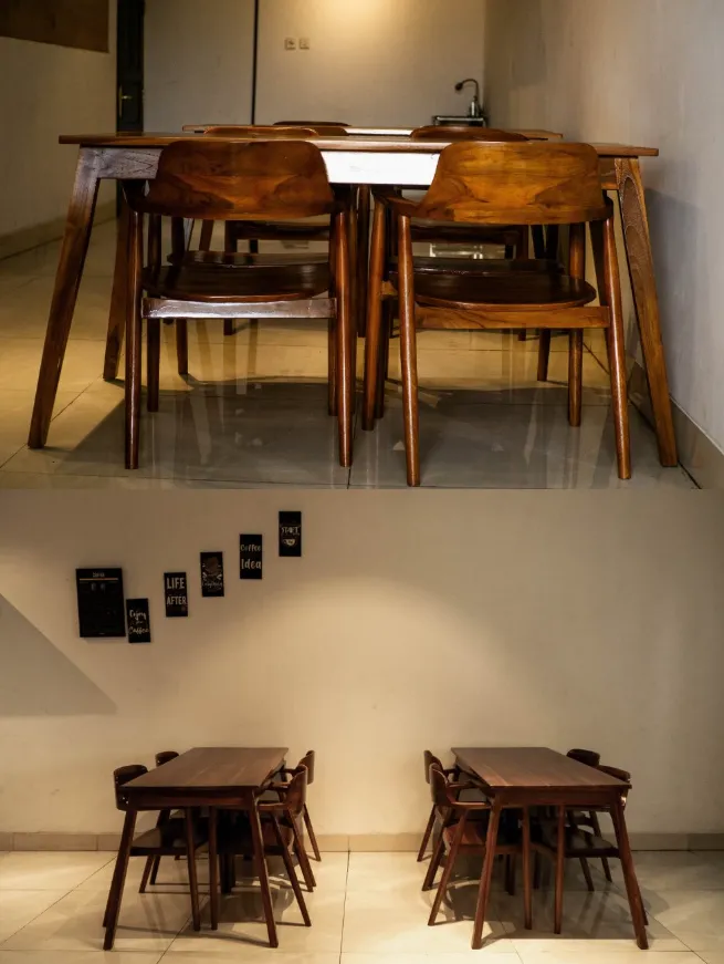Meja makan kayu jati dan area meja dengan hiasan dinding di indoor lantai dua ZA Coffee
